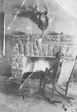 [ Annie Fraser, in front of Mowat Lodge fireplace ]